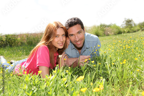 Couple of lovers laying donw in park photo