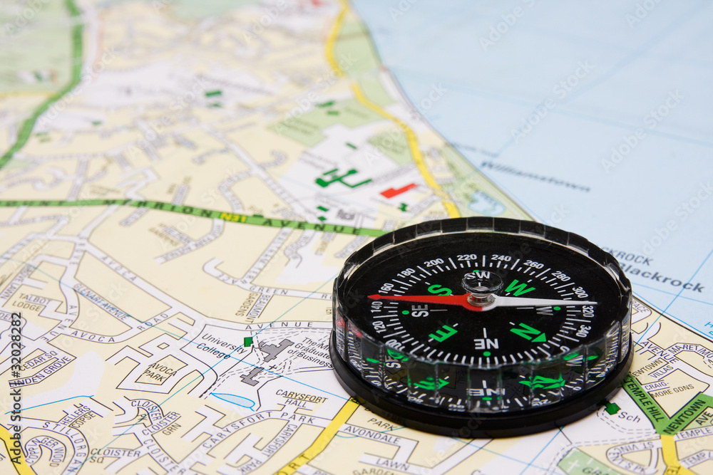 business travel concept. compass on city map background. business travel concept. compass on city map background.