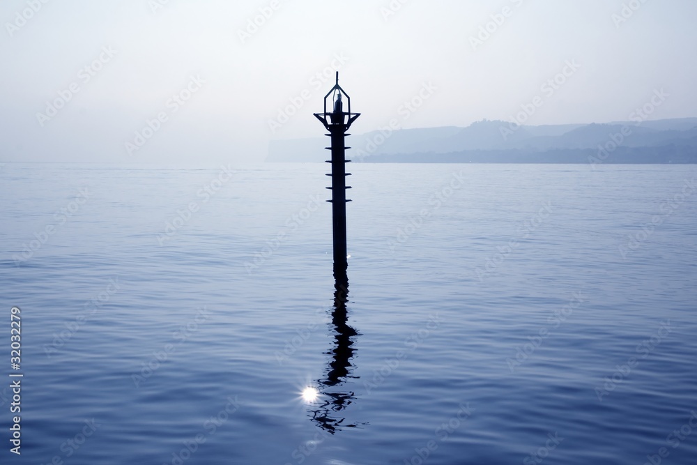 Obraz premium backlight beacon in Mediterranean blue sea reflection