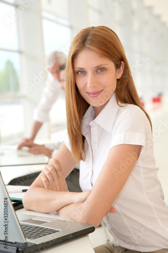 Portrait of smiling woman in the office Free Download Portrait of smiling woman in the office - GFXLoad
