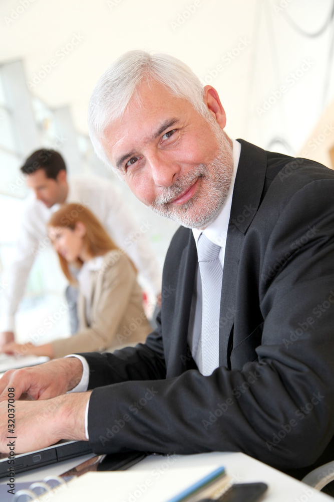 Senior businessman working on laptop computer Senior businessman working on laptop computer