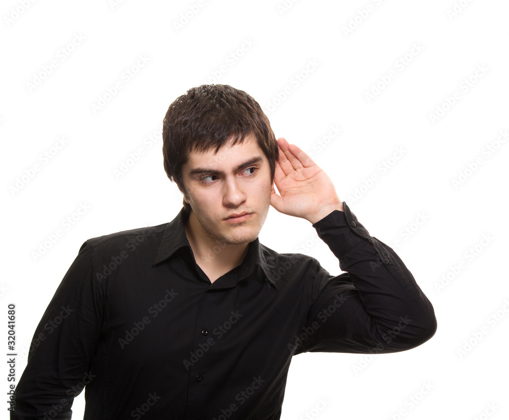 Young eavesdrop man in black shirt isolated on white background Young eavesdrop man in black shirt isolated on white background
