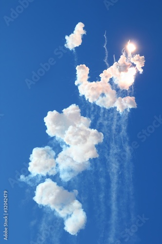 blue sky with fireworks firecrackers white clouds photo