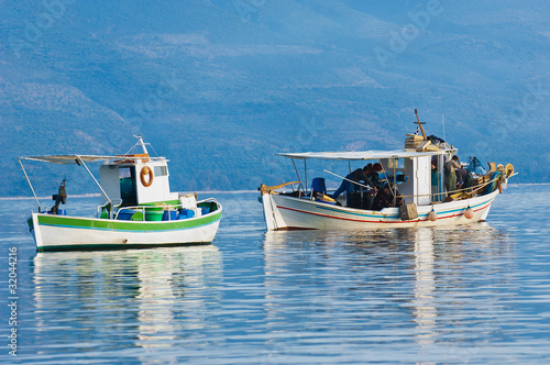 Fototapeta Two fishing boats in a southern Greece bay