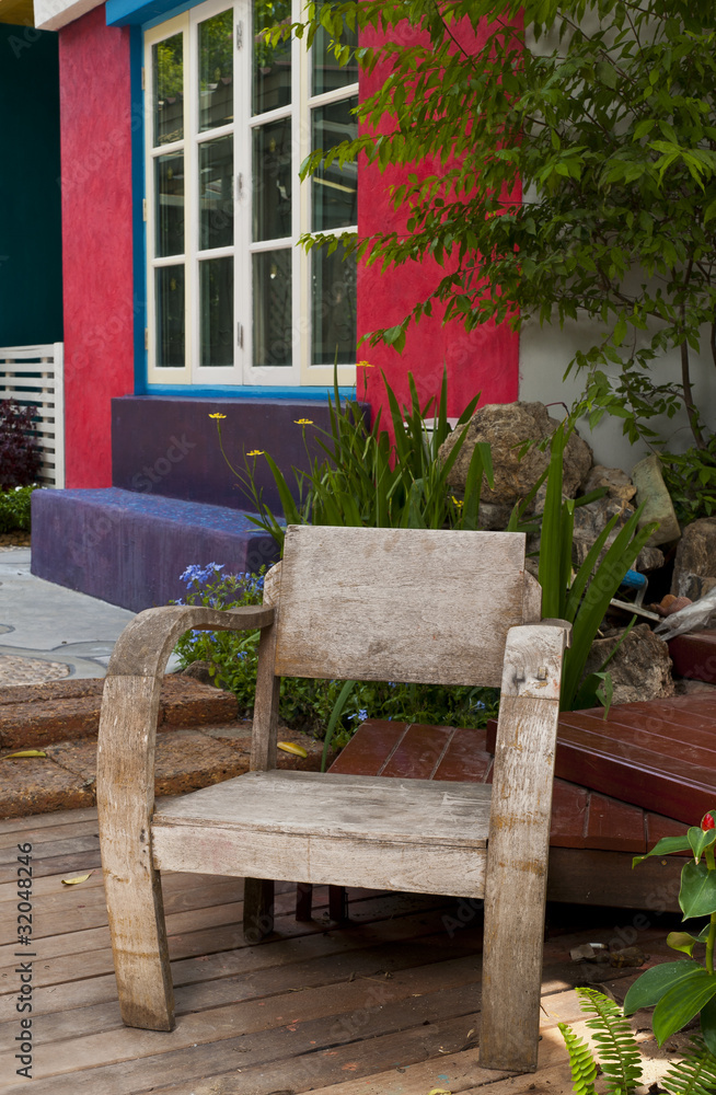 Old wooden chair in modern garden