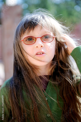 Portrait of beauty little brunette girl in sun glasses