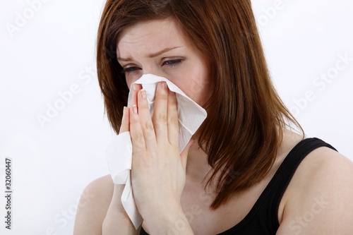 Young woman sneezing