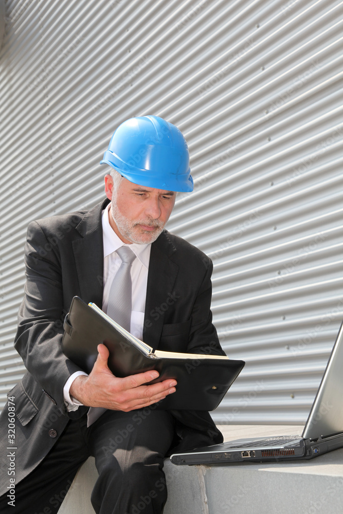 Site manager checking planning on computer Site manager checking planning on computer