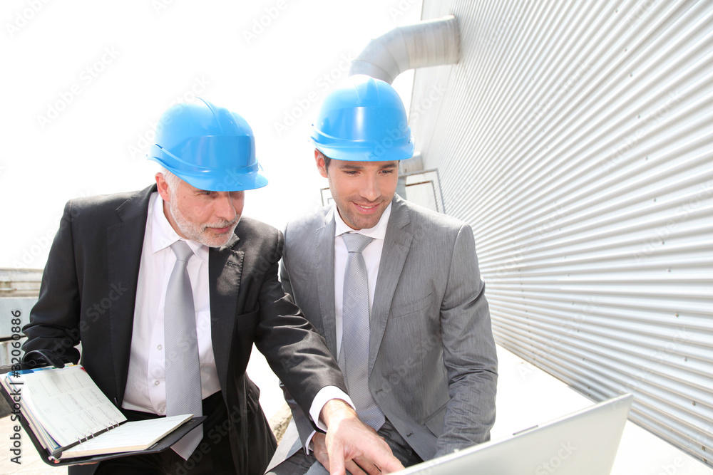 Business partners working on industrial site Business partners working on industrial site
