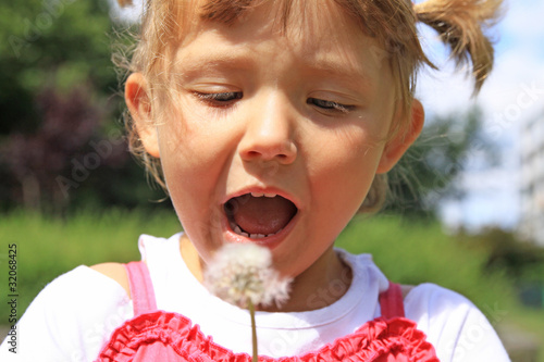 Girl blowing a dandelion