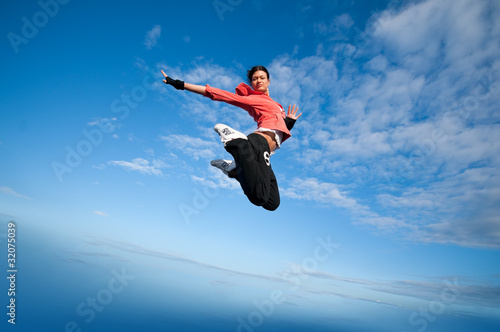 sport woman jumping and fly over sky