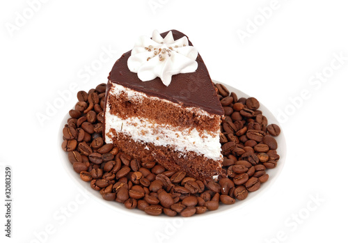 Slice of chocolate cream cake on coffee seed