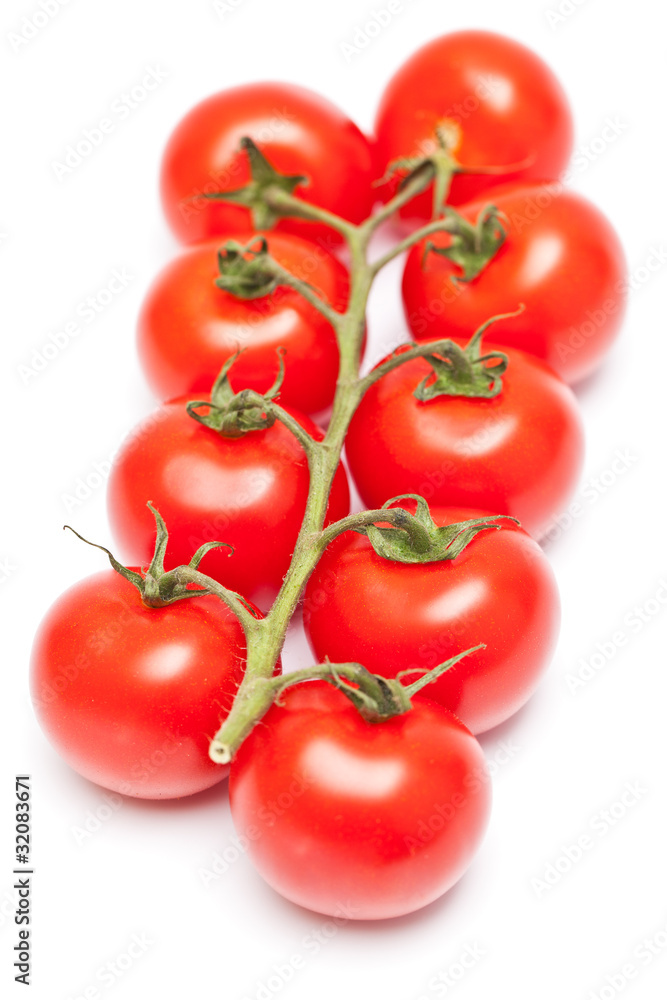 Stem of fresh ripe cherry tomatoes isolated on white background Stem of fresh ripe cherry tomatoes isolated on white background
