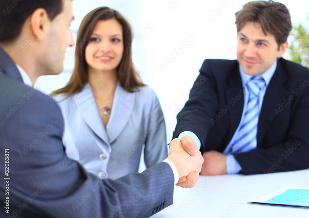 Business people shaking hands, finishing up a meeting Business people shaking hands, finishing up a meeting