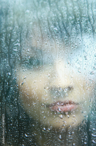 Sad young woman and a rain drops © ASDF