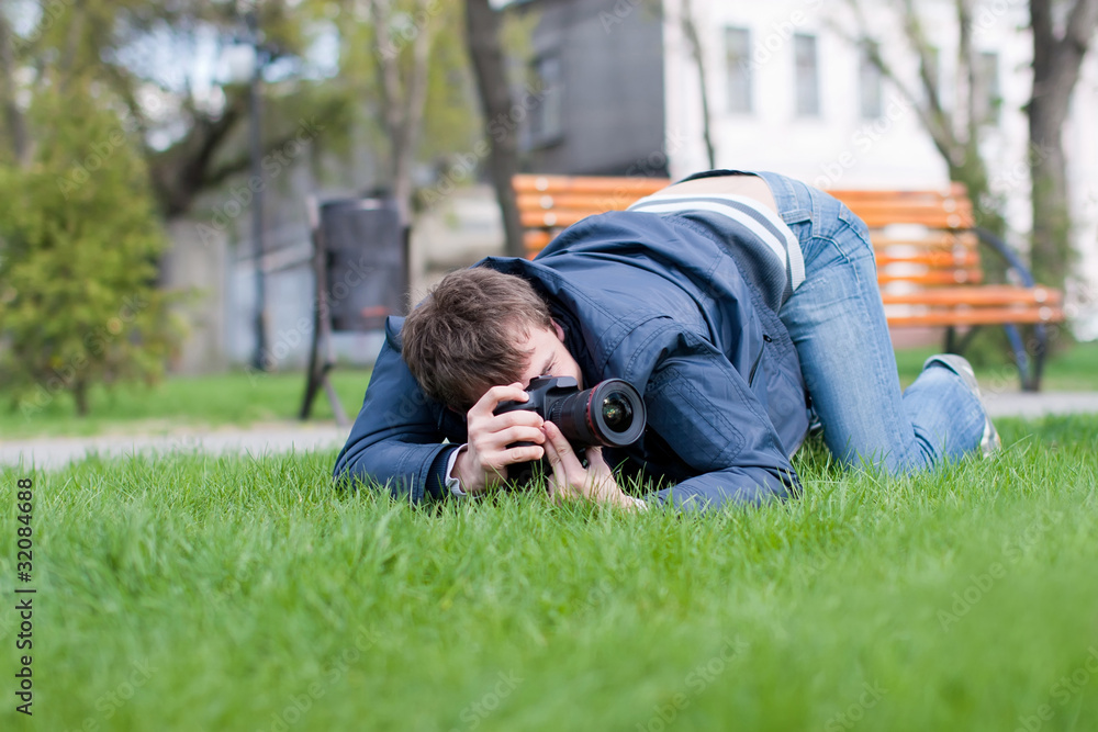 Photographer Takes a Shot on Green Grass