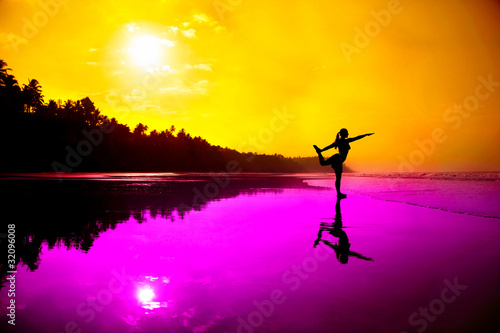 Yoga natarajasana on the beach