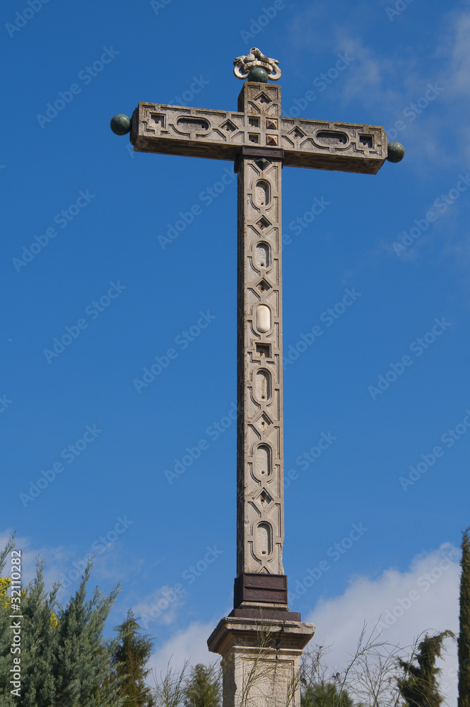 Stone Cross on blue sky