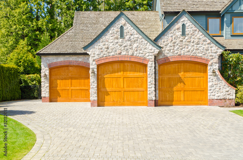 Fragment of a luxury house with triple garage door