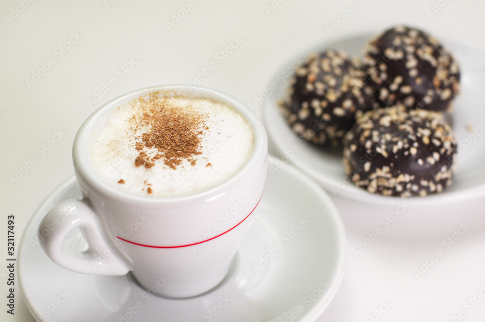 Cup of cappuccino coffee with chocolate candy Cup of cappuccino coffee with chocolate candy