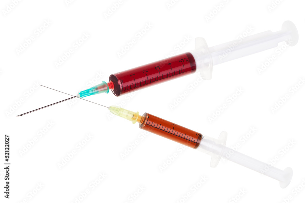 Fototapeta premium Two syringes with red liquid isolated over white background.