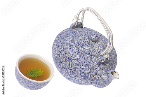 Chinese tea poured into a cup on isolated white background