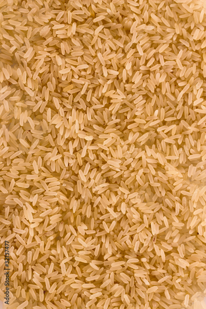 Brown uncoocked long rice as texture