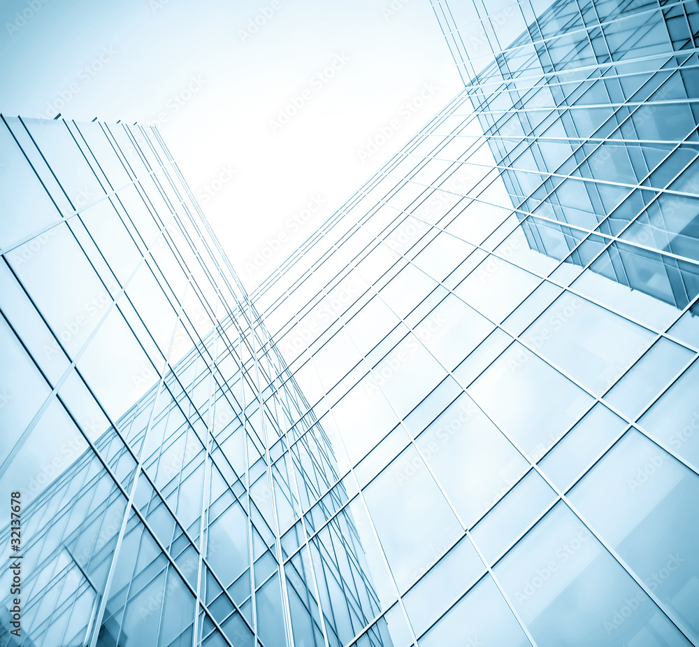 Obraz premium low angle view to light glass buildings of business center