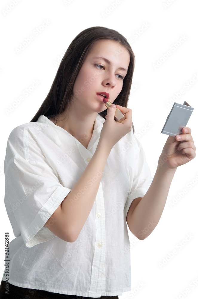 A young girl with her hair applying lipstick A young girl with her hair applying lipstick