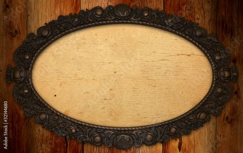 фотографія antique frame with blank paper on knotty wood wall