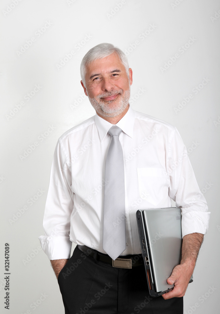 Businessman standing with laptop computer Businessman standing with laptop computer