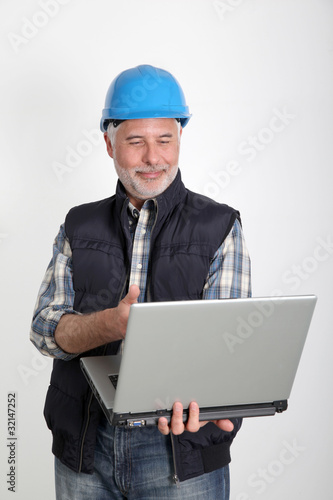Construction worker using laptop computer