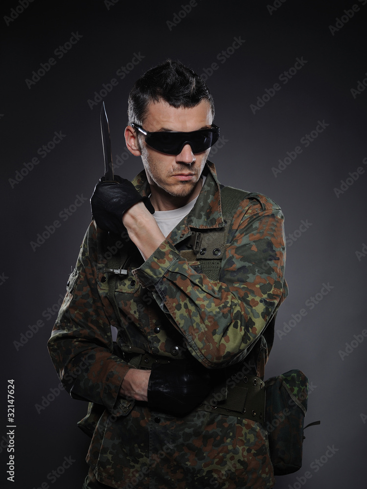 portrait of soldier in camouflage and ammunition with knife. stu portrait of soldier in camouflage and ammunition with knife. stu
