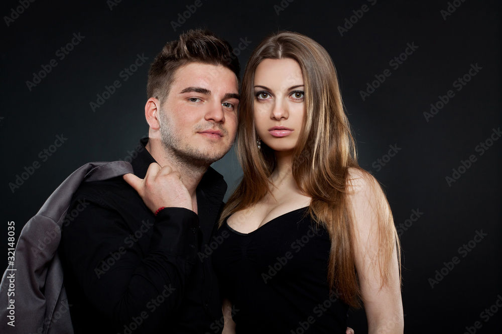 young couple standing next to each other young couple standing next to each other