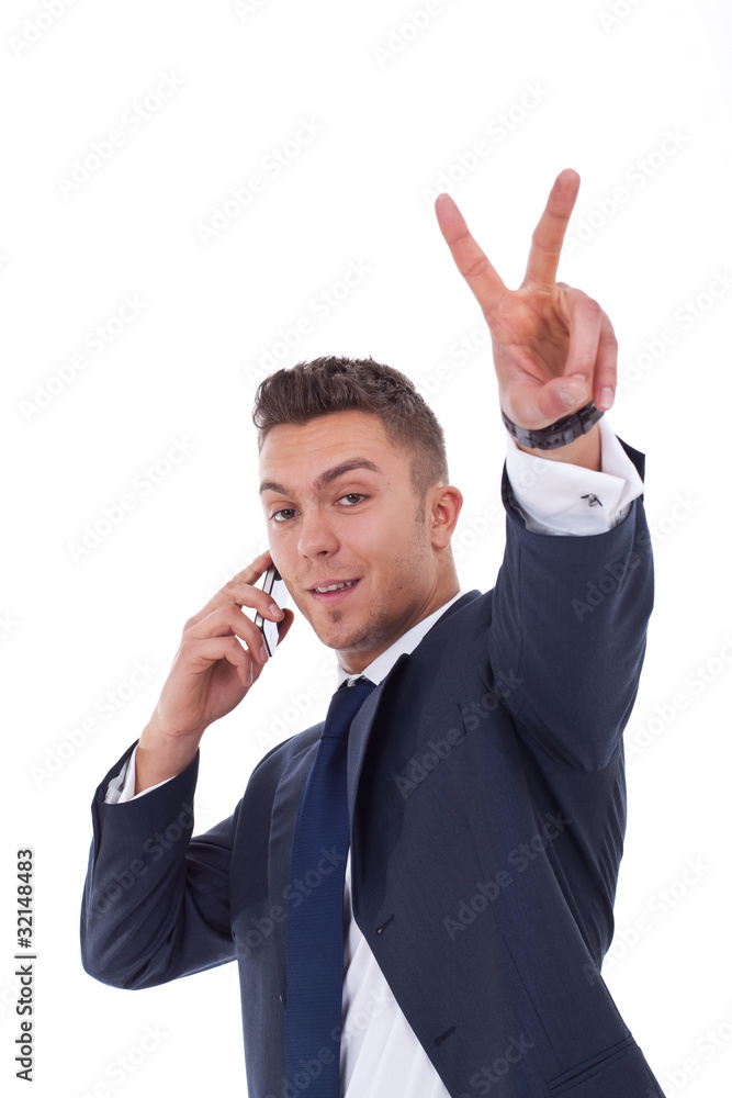 businessman making victory sign while talking on the phone businessman making victory sign while talking on the phone