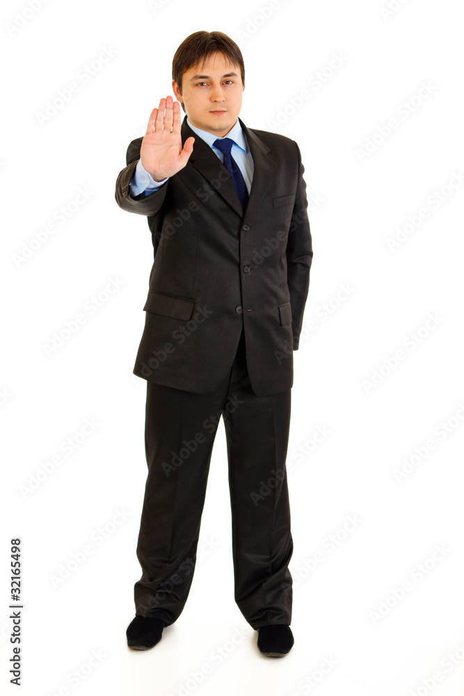 Confident modern businessman showing stop gesture Confident modern businessman showing stop gesture