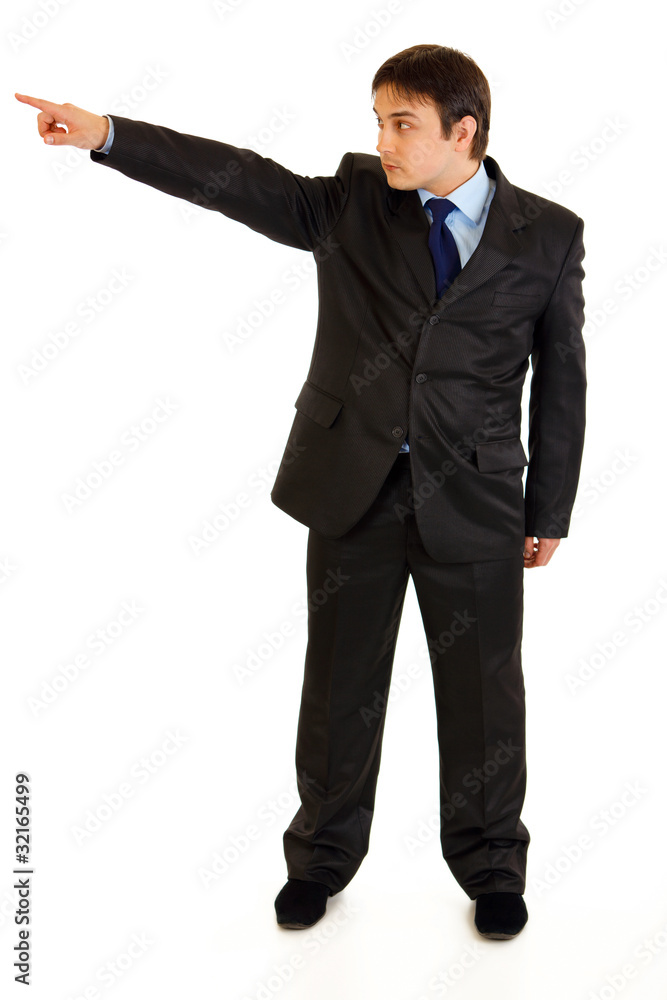 Confident businessman pointing in corner isolated on white. Confident businessman pointing in corner isolated on white.