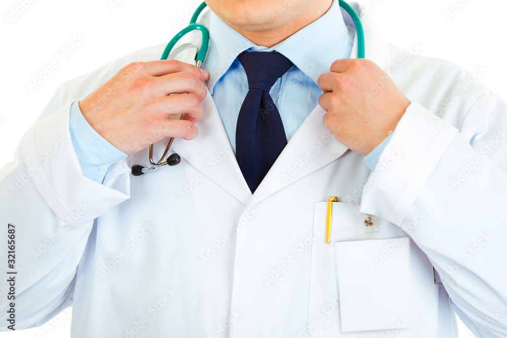 Medical doctor straightening stethoscope. Close-up.