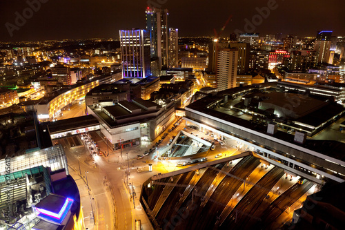 Birmingham City Centre illuminated at night overlooking New Street Station from the Rotunda, Bwith bustling streets and glowing station platforms