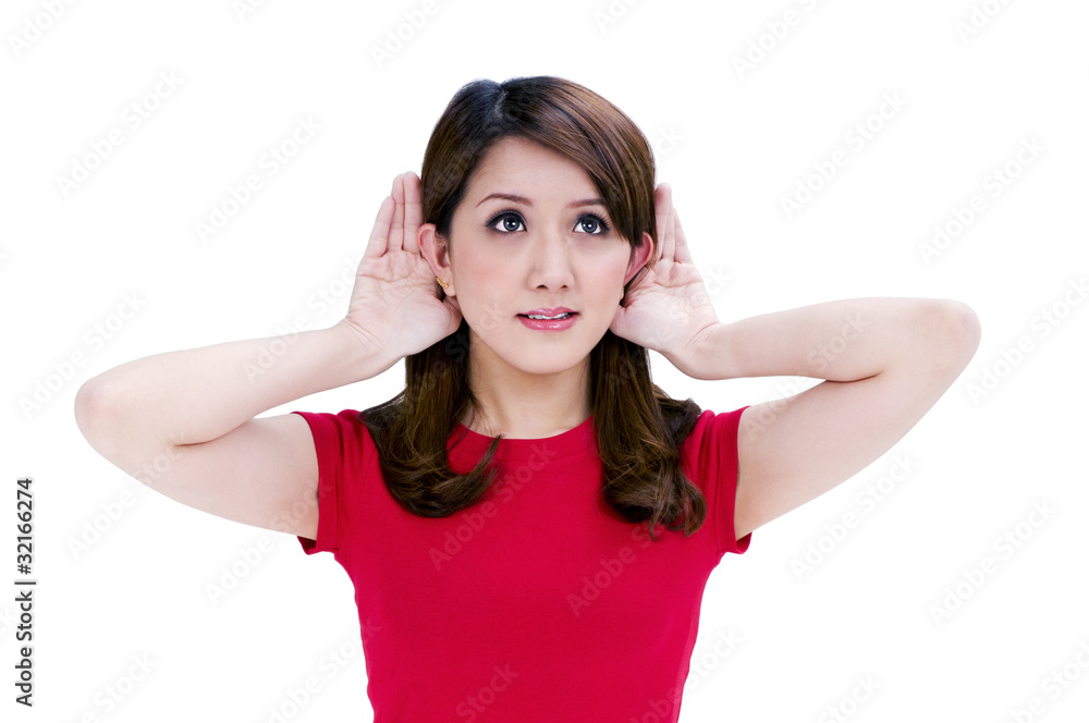 Attractive young woman with hands behind her ears Attractive young woman with hands behind her ears