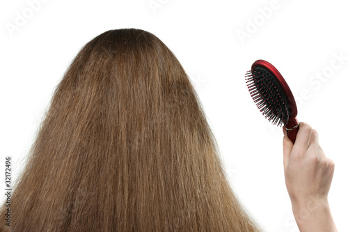 The girl with long hair and a hairbrush