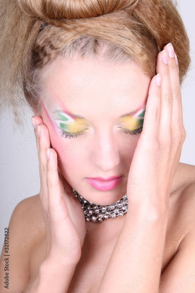 Young woman with creative make-up and coiffure Young woman with creative make-up and coiffure