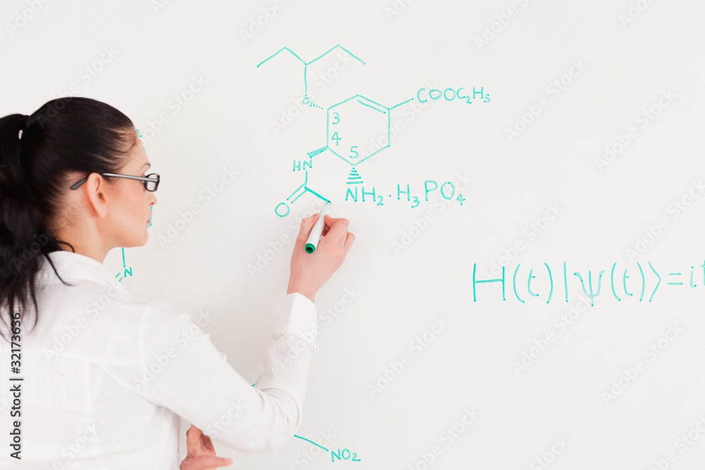 Scientist writing a formula Scientist writing a formula