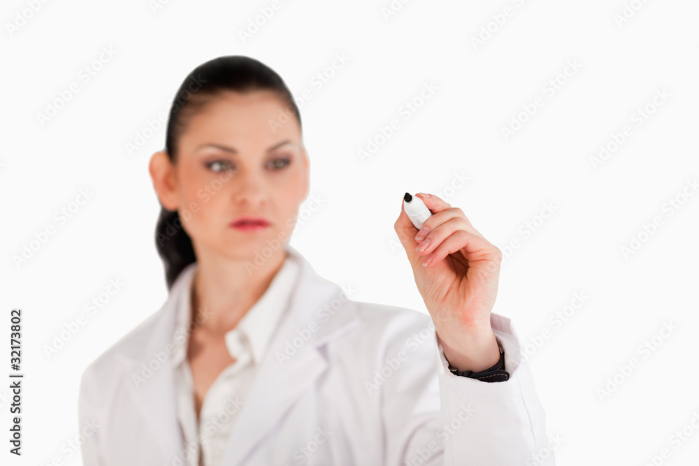 Dark-haired scientist writing on an empty white board Dark-haired scientist writing on an empty white board