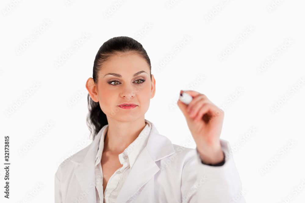 Dark-haired scientist writing on an empty white board Dark-haired scientist writing on an empty white board