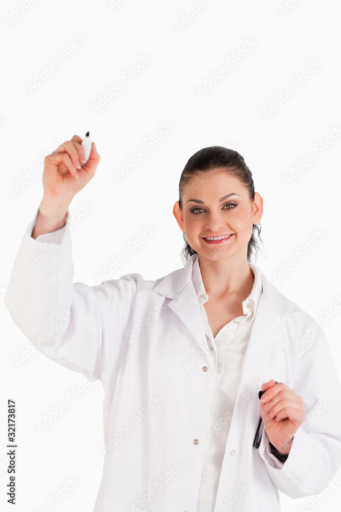 Smiling scientist writing on an empty white board Smiling scientist writing on an empty white board