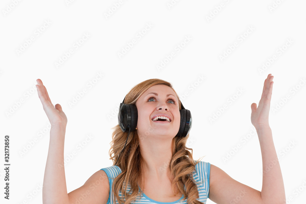 Fototapeta premium Isolated blond-haired woman happy while listening to music