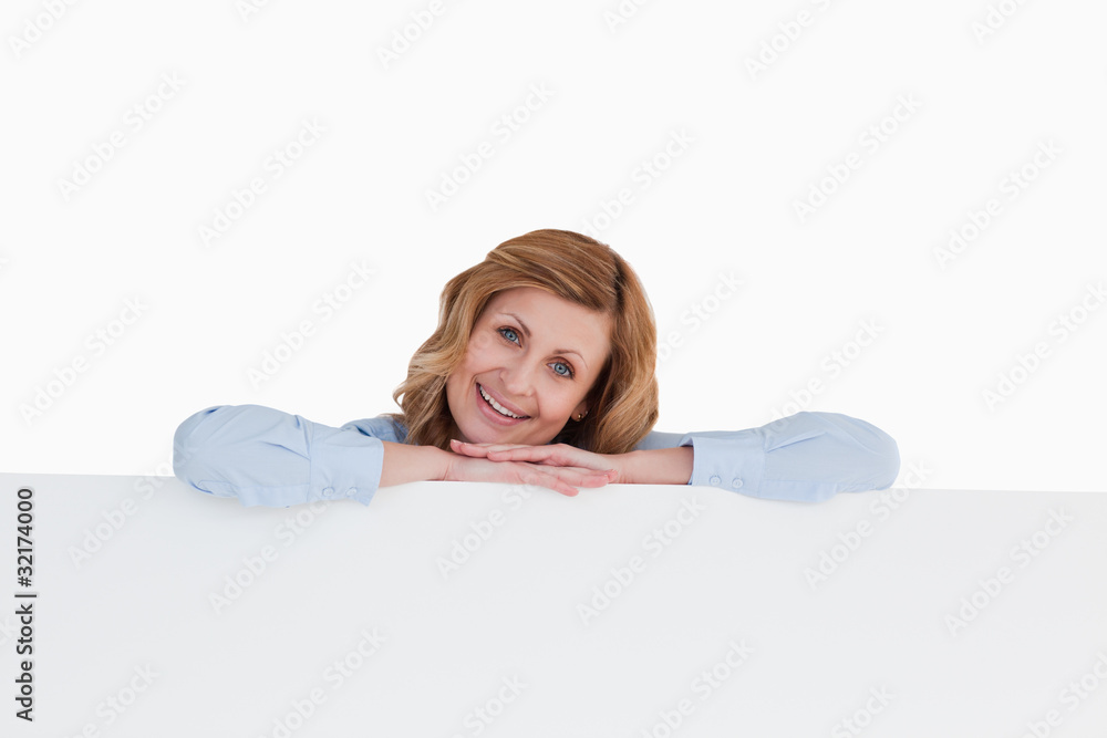 Smiling blond-haired woman standing behind a white board Smiling blond-haired woman standing behind a white board