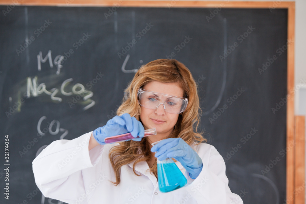 Young blond-haired woman carrying out an experiment