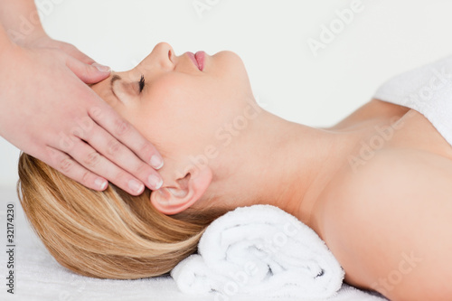 Young blond-haired woman receiving a spa treatment